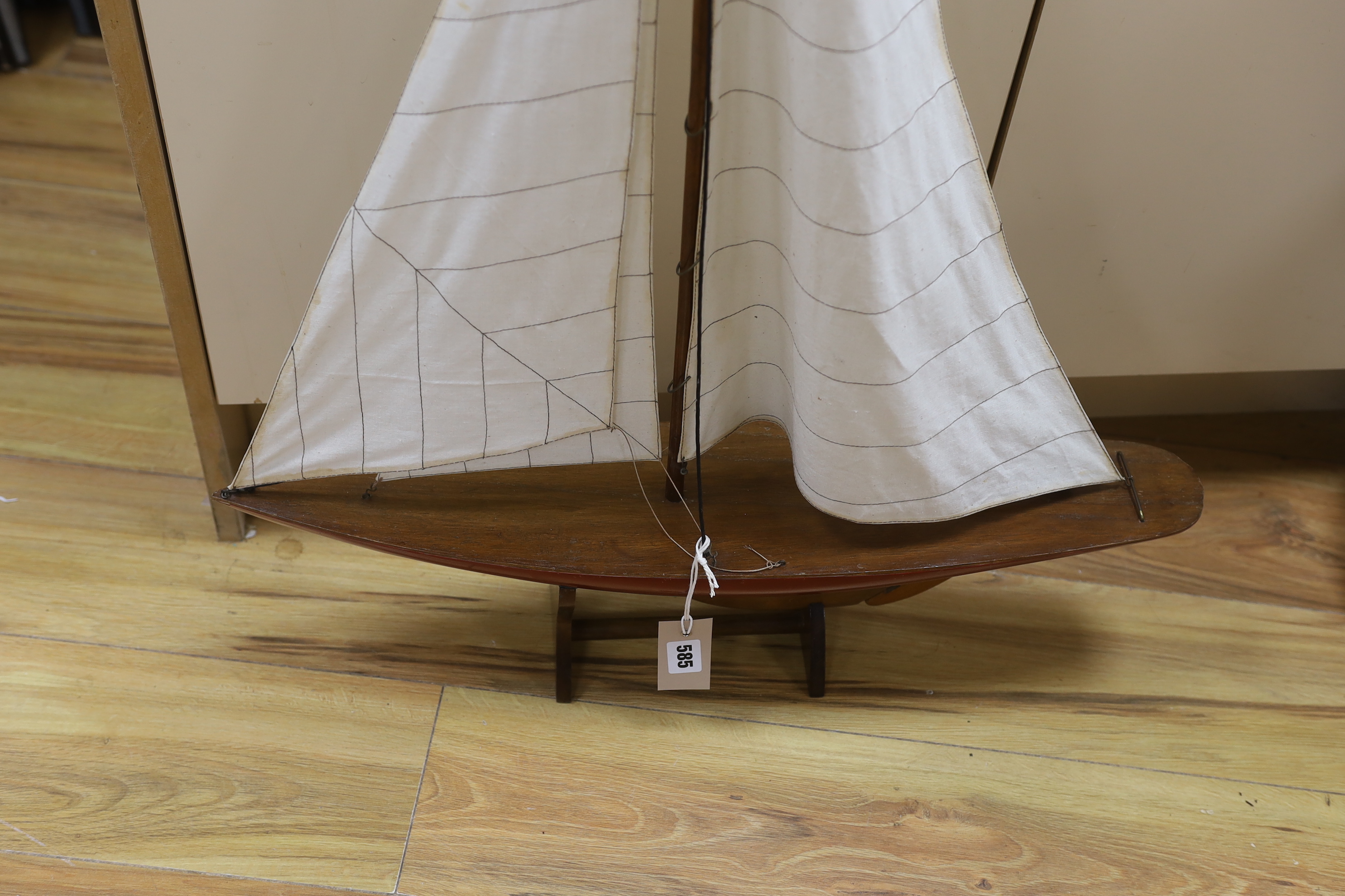 A painted wood pond yacht with fabric sails on stand, 97cm high